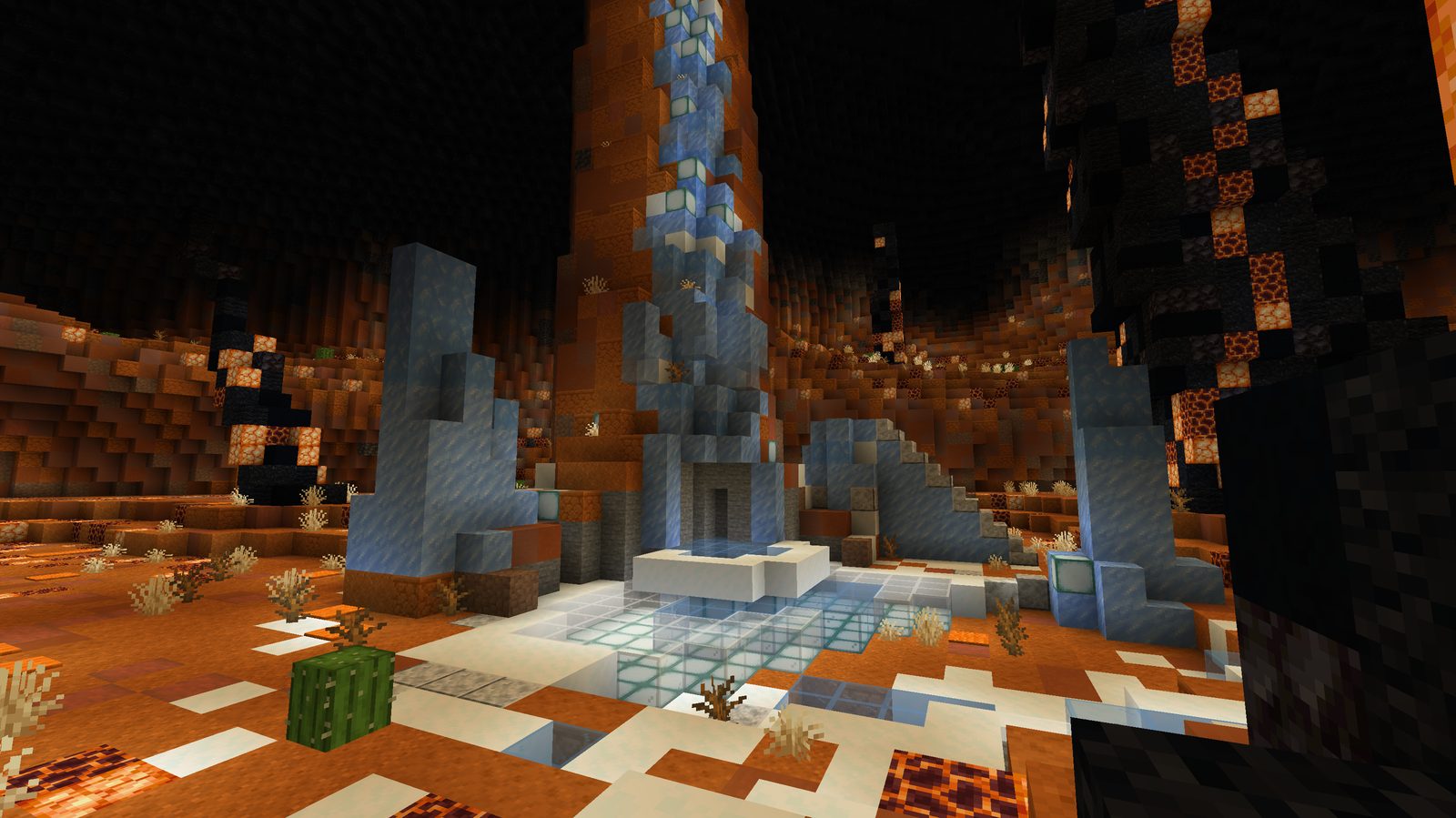 An ice waterfall and packed ice crystals in an orange cavern