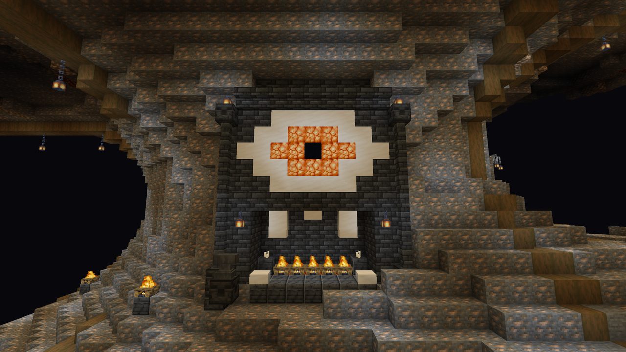 A carved face with a single quartz eye and a fire mouth in an iron ore wall