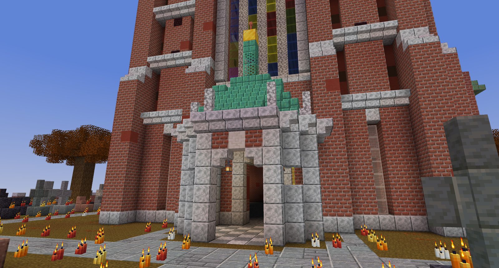 A brick basilica porch with candles and pumpkins in the churchyard