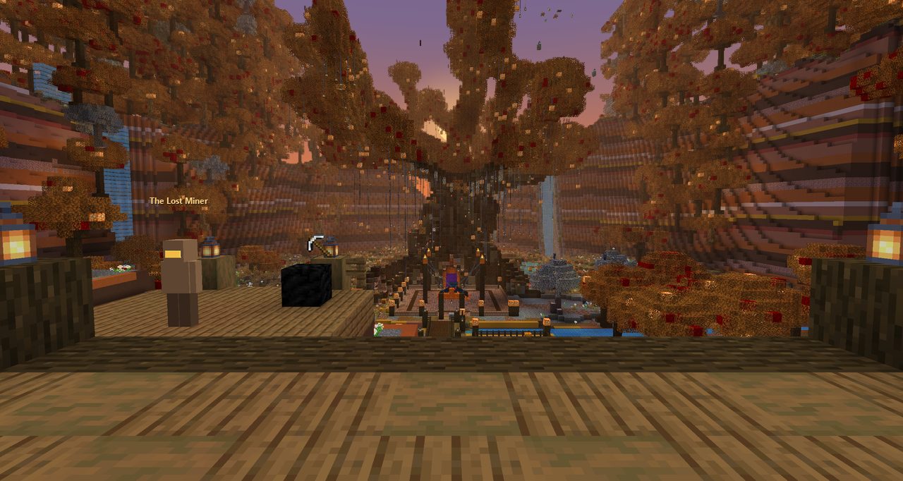 A huge autumn tree seen across a wooden deck at dusk